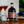 Load image into Gallery viewer, Newy Distillery Caramel Espresso Martini Bottle 700ml. Displayed on brown wooden tablen next to small pot of pretzels and scattering of coffee beans. Two Caramel Espresso Martini cocktails behind, with bag of pretzels on blue and white cloth in the background.
