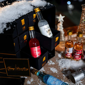 12 Day Gin Advent Calendar Christmas 2023 - Newy Distillery. Gin Advent calendar in snow scene, Christmas crackers. Boozy Advent Calendar.