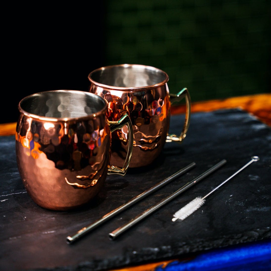 Hammered Copper Moscow Mule Mugs with metal straws and straw cleaning brush. Newy Distillery.