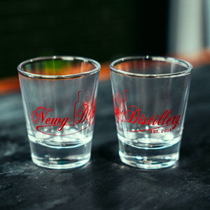 50ml shot glasses by Newy Distillery. Empty glasses on grey slate.