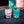 Load image into Gallery viewer, 50ml shot glasses by Newy Distillery. One glas with pink vodka, one glass with turquoise vodka.
