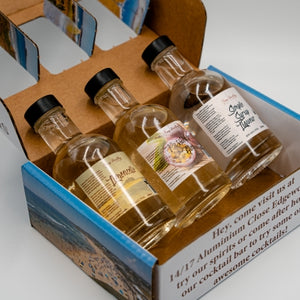 Passionfruit Gin Caipiroska Cocktail Kit by Newy Distillery. Gift box, open with bottles displayed inside.