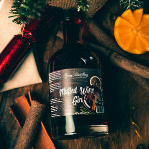 Mulled Wine Gin by Newy Distillery. Award Winning Gin. 500ml bottle displayed in christmas scene with fresh orange, cinnamon sticks, Christmas crackers.