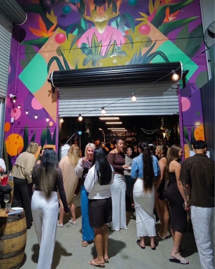 Arrivals under the mural at the roller door